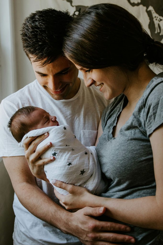 Perinatal mental health: a couple holds a baby.